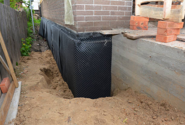 Happy homeowners after waterproofing job in Langston